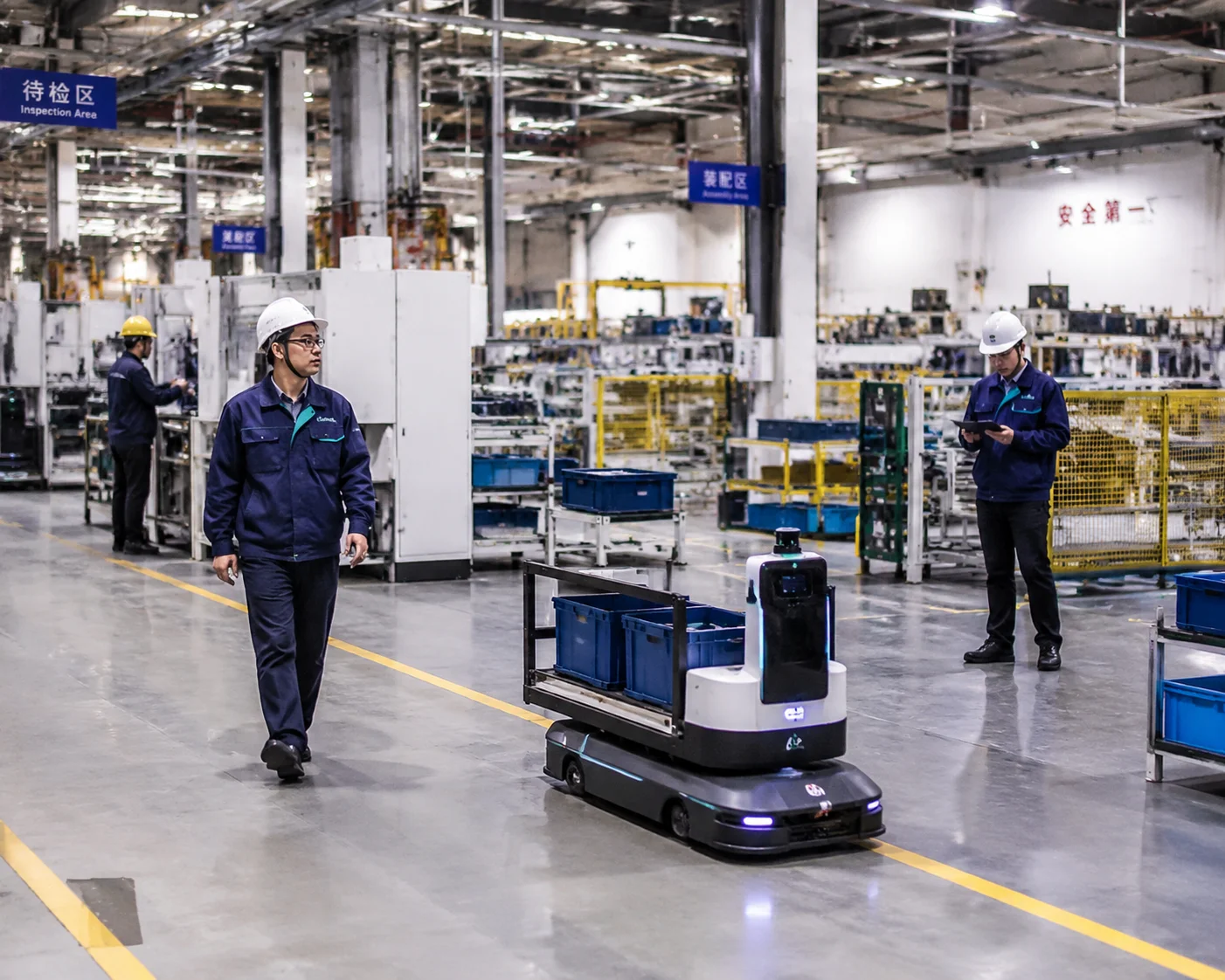 Factory AMR material handling robot operating in an industrial warehouse environment